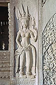 Angkor Wat temple, second enclosure, devatas sculpted in bas-relief with an extraordinary variety of intricate hair styles and costumes. 